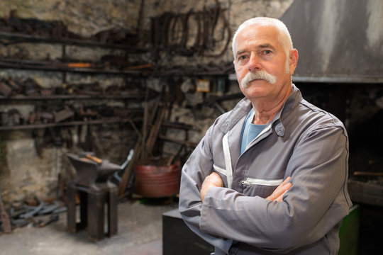 old blacksmith posing arms crossed