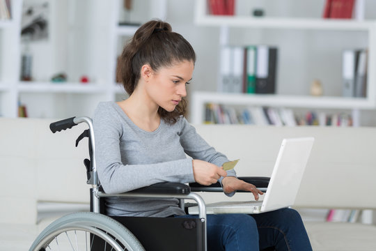 happy adult handicapped woman with laptop indoor