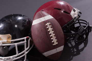american football and helmets isolated on gray