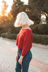 Attractive young woman with nice hair are walking in the city at evening.