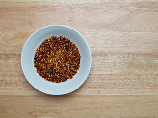 Porcelain bowl filled with red pepper flakes
