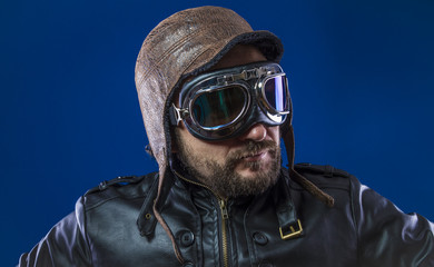 pilot of the 20s with sunglasses and vintage aviator helmet. Wears leather jacket, beard and expressive faces