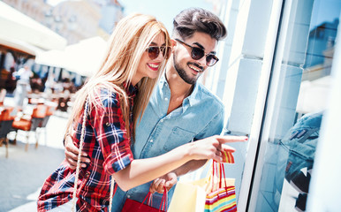 Shopping time. Young couple in shopping. Consumerism, love, dating, lifestyle concept