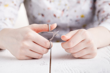 Obraz na płótnie Canvas Health and personal care: Hand holding scissors for manicure
