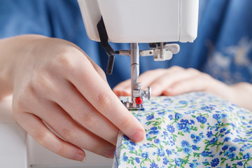 working with needle and thread and sewing machine with a colored thread