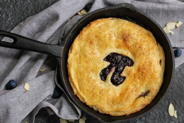 Homemade Skillet  Blueberry Pie with cut out Pi  day writing top down view