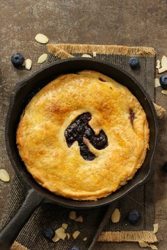 Homemade Skillet  Blueberry Pie with cut out Pi  day writing top down view