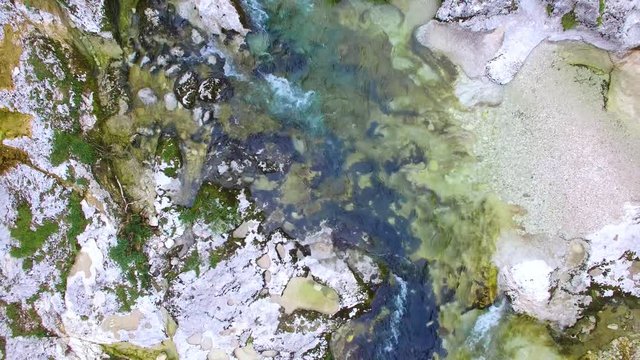 AERIAL vertical view: flight over the surface of a mountain river