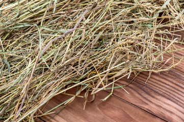 Hay on wooden background. Close up.