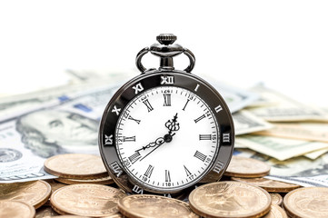 Pocket watch with coins and dollar bills on white background.