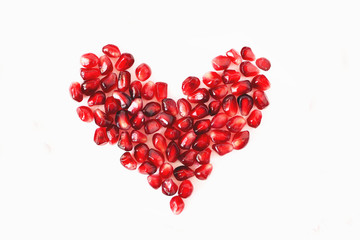 heart of red pomegranate seeds on a white background, Valentine