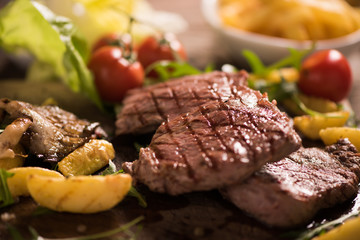 grilled meat with herbs on wooden board