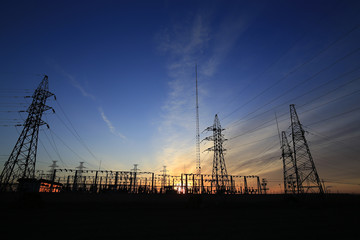 Fototapeta premium A high voltage substation in the sky at sunrise