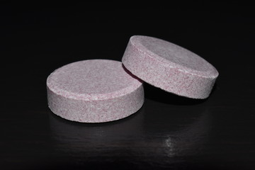 Medicine pills closeup on black background