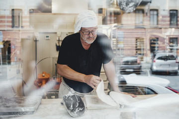 Baker leafing through recipe book