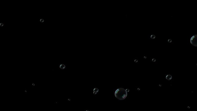 Soap bubbles fall down on black background