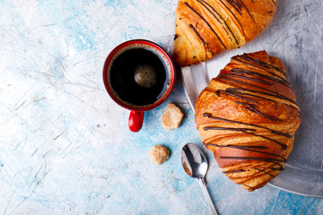   Breakfast Continental  with Fresh  Croissants on a blue Background Breakfast in bed. Coffee  and Delicious Baking with  with Chocolate Topping  Top View Copy space for Text
