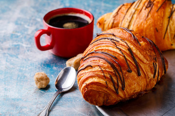   Breakfast Continental  with Fresh  Croissants on a blue Background Breakfast in bed. Coffee  and Delicious Baking with  with Chocolate Topping
