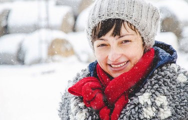 Portrait of beautiful happy woman enjoying winter and snow