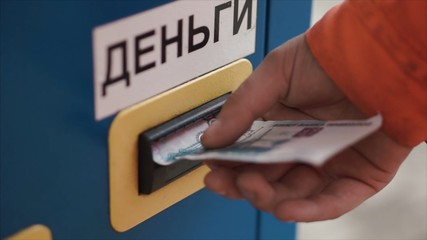 Man Inserting Cash Into Machine At Parking Lot close-up. Clip. Hand inserting banknote into vending machine