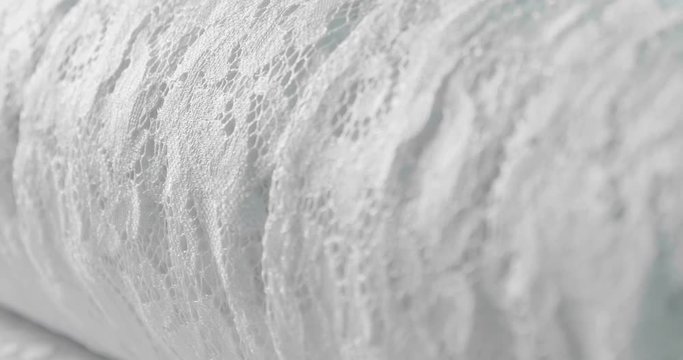 Macro shot of a lace, fabric used to make elegant wedding dresses for the wedding day. Concept of: tailoring, colors, bride and marriage