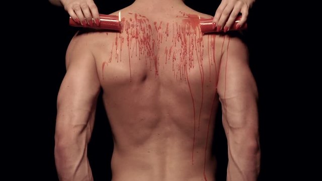 Dripping wax on a male body