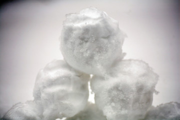 real snowballs with their hands clasped from the fresh snow in winter on the street