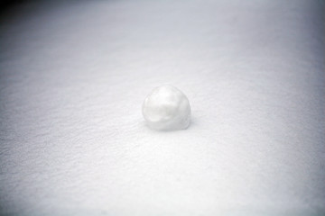 real snowballs with their hands clasped from the fresh snow in winter on the street
