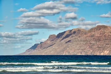 Landscape with volcanic hills and atlantic ocean in Lanzarote
