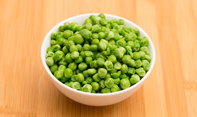 Steaming Hot Peas on a Wooden Table