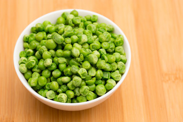 Steaming Hot Peas on a Wooden Table