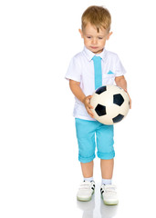 A little boy is playing with a ball.
