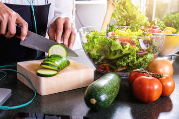 Young happiness Woman Cooking vegetables salad in the kitchen, Healthy food concept