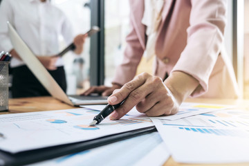 Team work process. young business managers crew working with new startup financial project. labtop on wood table, typing keyboard, texting message, analyze graph plan