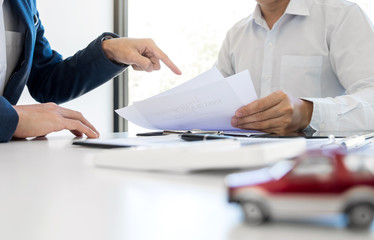 Agent man presentation and consulting car insurance detail to customer and waiting for his reply to...