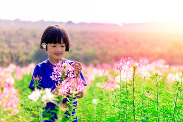 Asian small girl playing farm flower in sunny day happy and enjoyed beautiful weather