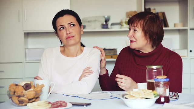 Portrait upset female looking away after conflict, mother talking at home interior