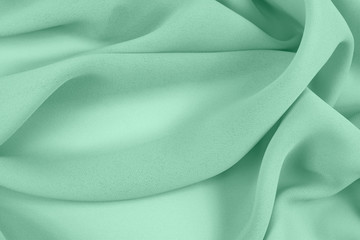 Texture satin fabric green color for the background  