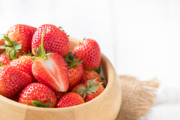 fresh sliced Red berry strawberries in wood bowl