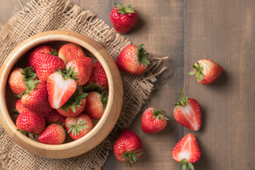 resh sliced Red berry strawberries in wood bowl