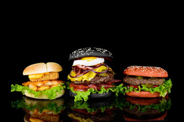 assorted burgers on a black background