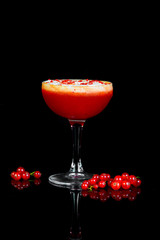 alcoholic drink with berries on a black background