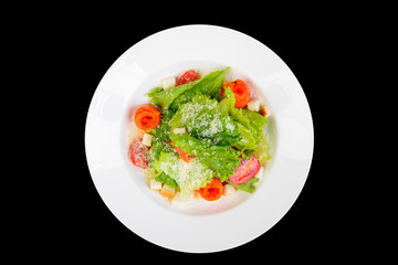 fresh vegetables salad with cheese on black background