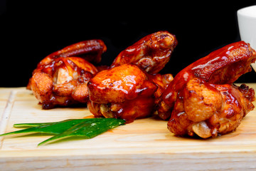 fried chicken wings with a black background