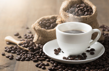 Cups of coffee with smoke and coffee beans