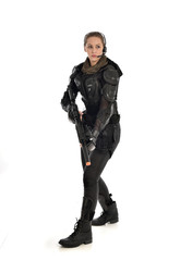 full length portrait of female  soldier wearing black  tactical armour, holding a rifle gun, isolated on white studio background.