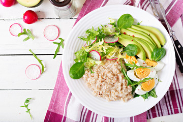 Healthy breakfast. Dietary menu. Oatmeal porridge and avocado salad and eggs. Top view