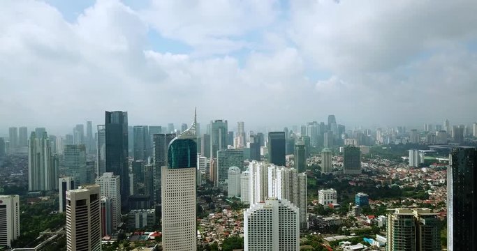 JAKARTA - Indonesia. March 01, 2018: Stunning aerial landscape from flying drone of Jakarta downtown with modern skyscrapers background. Shot in 4k resolution