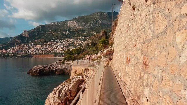 Fast Moving Action Hyperlapse POV. Walk on a Footbridge Over The Mediterranean Sea in Roquebrune-Cap-Martin on The French Riviera - 4K Video
