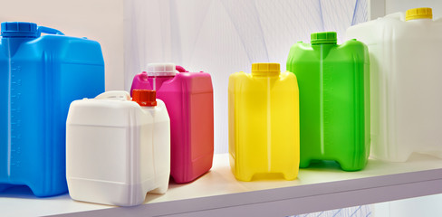 Empty colorful plastic cans for liquids in store